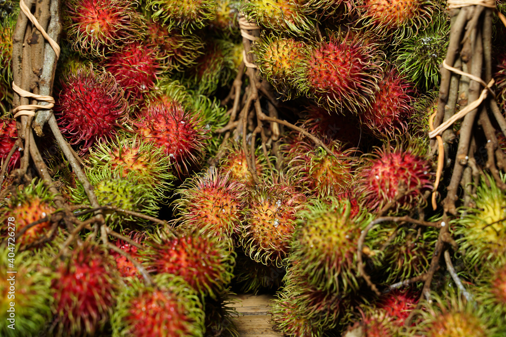 Front view healthy fruits rambutans on a container. The sweet fruit is single-seeded berry covered with fleshy pliable spines. rambutans is a tropical plant originating from areas in Asian. Front view healthy fruits rambutans on a container. The sweet fruit is single-seeded berry covered with fleshy pliable spines. rambutans is a tropical plant originating from areas in Asian.