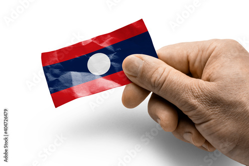 Hand holding a card with a national flag the Laos