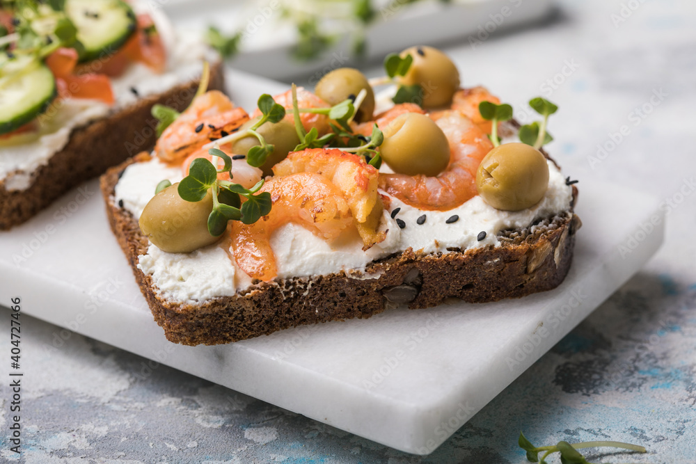 Prawns toast with a micro-green, olives on wooden background, concept of healthy eating, assortment of bruschetta Prawns toast with a micro-green, olives on wooden background, concept of healthy eating, assortment of bruschetta