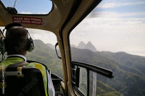 Looking over the shoulder of a helicopter pilot flying over the iconic Pitons on the island of Saint Lucia in the Caribbean