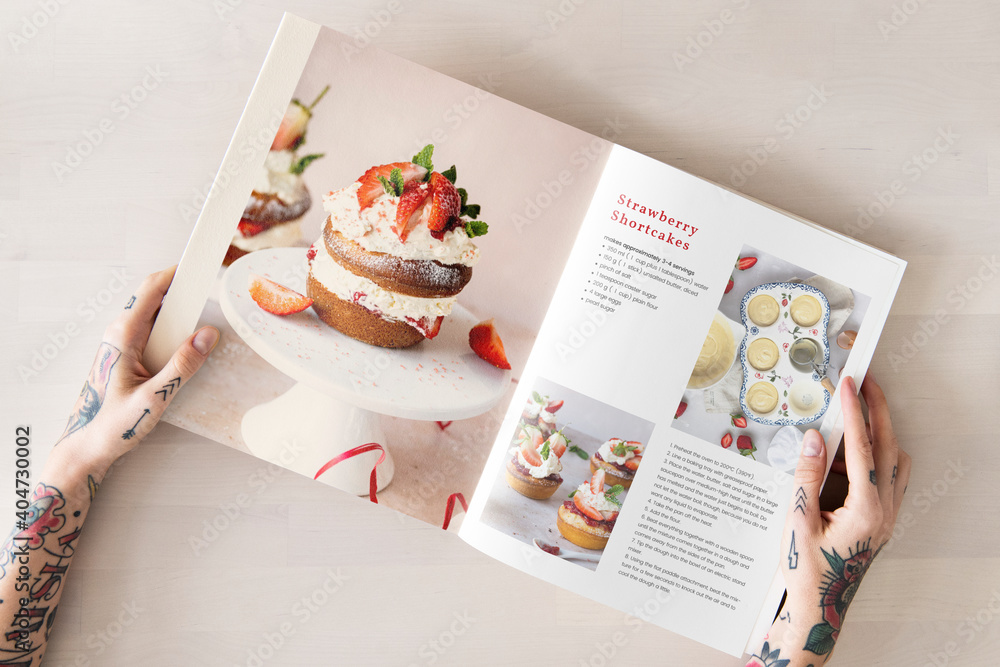 Behang Woman reading from a recipe cookbook flat lay