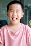 headshot toothy smiling face of asian children