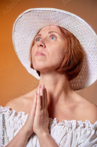 Portrait of ugle middle-aged woman with hat. A model posing in a rustic style in a Studio. photo