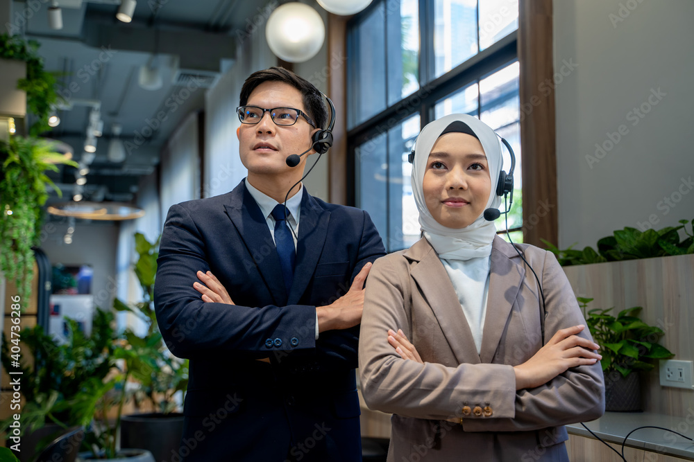 Portrait of businessman and Muslim lady employee standing in office.Work concept of diversity of culture different race type of people co-working together. Portrait of businessman and Muslim lady employee standing in office.Work concept of diversity of culture different race type of people co-working together.