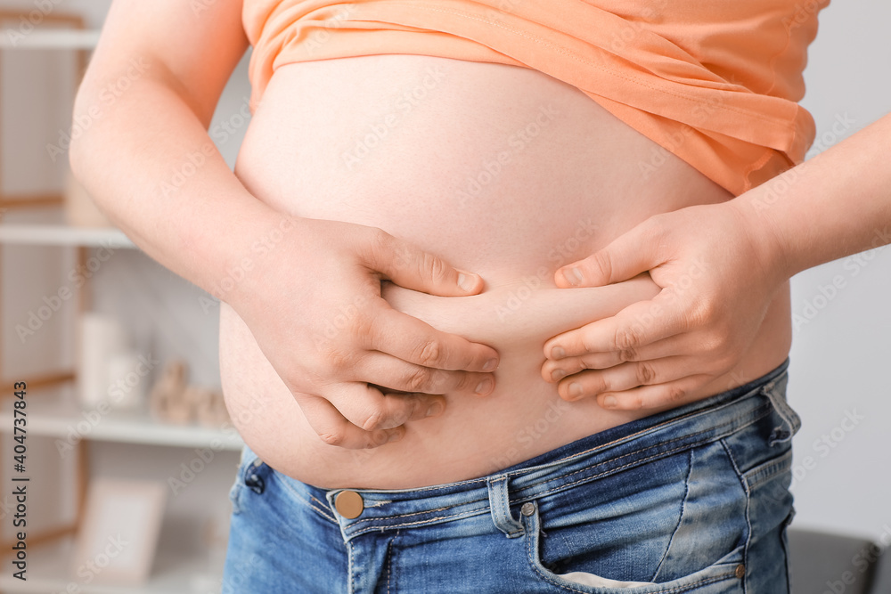 Overweight man at home. Weight loss concept Overweight man at home. Weight loss concept