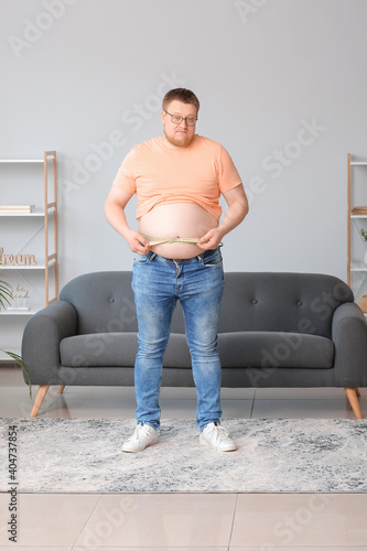 Sad overweight man with mea...