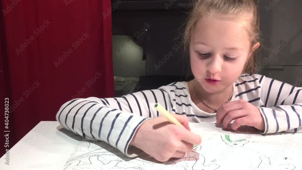 little Girl with white hair, in a striped sweater. Very passionate and serious. He paints, draws on a large sheet of white paper, using multi-colored markers or pencils. Be in your children's room. little Girl with white hair, in a striped sweater. Very passionate and serious. He paints, draws on a large sheet of white paper, using multi-colored markers or pencils. Be in your children's room.