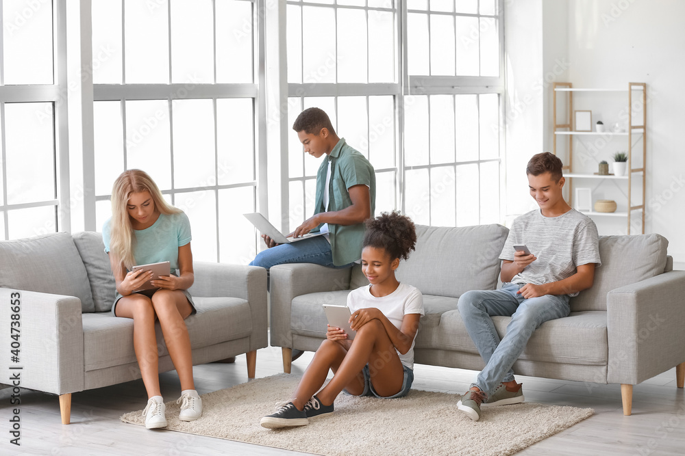 Teenagers with different devices at home Teenagers with different devices at home