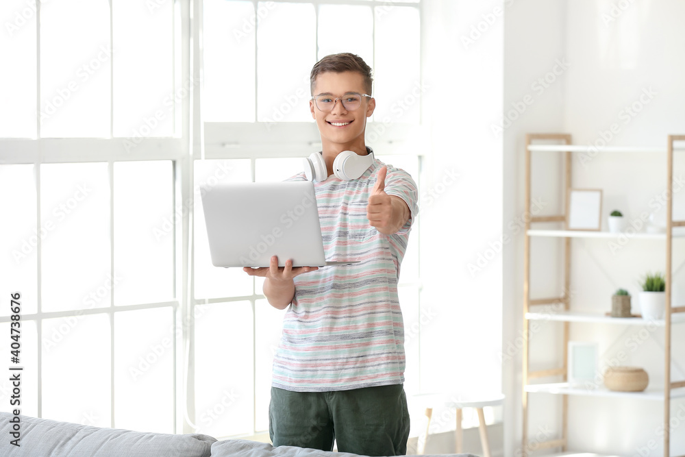 Happy teenage boy with laptop at home Happy teenage boy with laptop at home