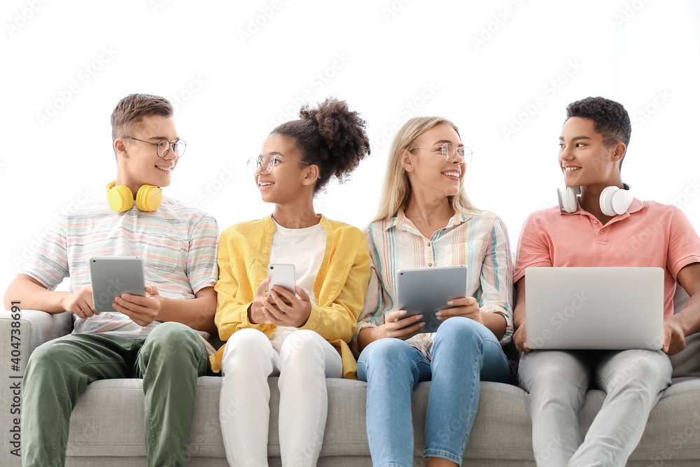 Teenagers with different devices at home Teenagers with different devices at home