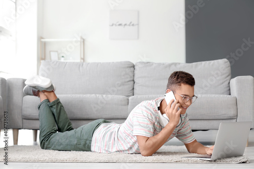 Teenage boy with laptop tal...