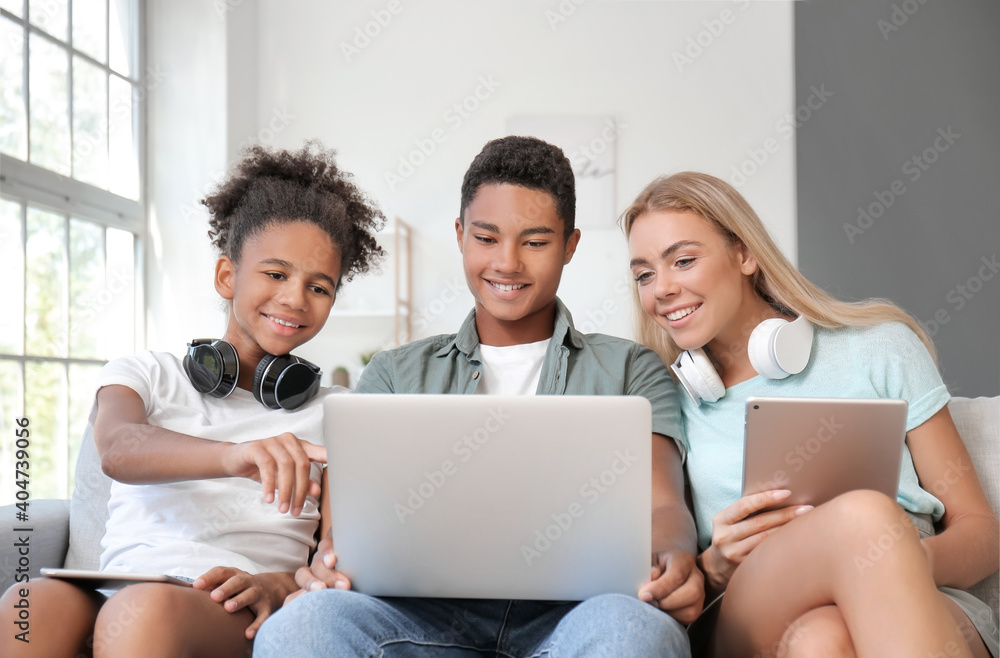 Teenagers with different devices at home Teenagers with different devices at home
