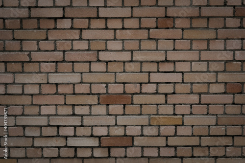 Big red brown brick wall with rough and uneven, bricklayer for a backdrop and template with space for text, no person