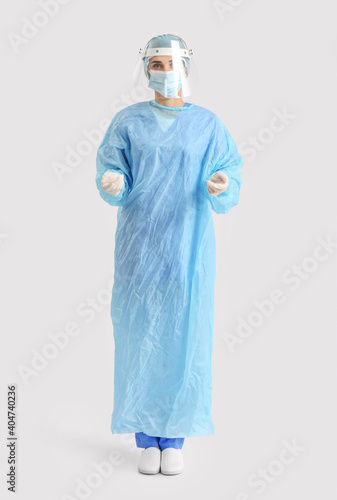 Portrait of female surgeon on light background