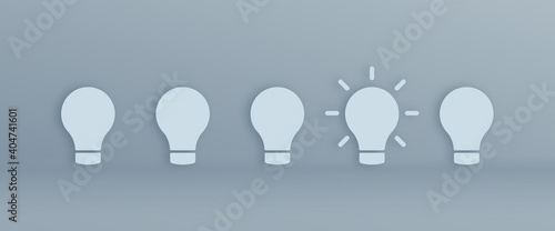An active light bulb between light bulbs is the inspiration for entrepreneurship. Modern and minimal design of separate light bulb ''Wide version''.