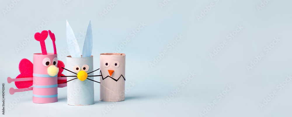 Paper toy Happy Easter home party. Easy crafts for kids on blue background, copy space, die creative idea from toilet tube roll, recycle reuse eco concept, kindergarten daycare, banner