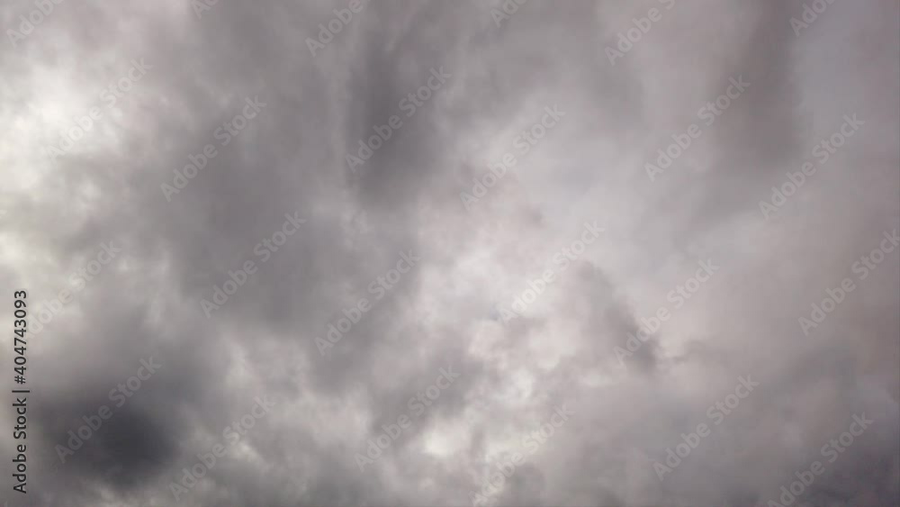 Bad weather and ominous stormy grey sky with wall thunderclouds rolling fast in the air Bad weather and ominous stormy grey sky with wall thunderclouds rolling fast in the air