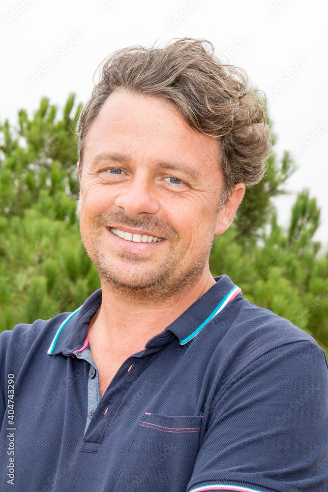 Handsome man portrait middle aged smiling in summer day outdoor Handsome man portrait middle aged smiling in summer day outdoor