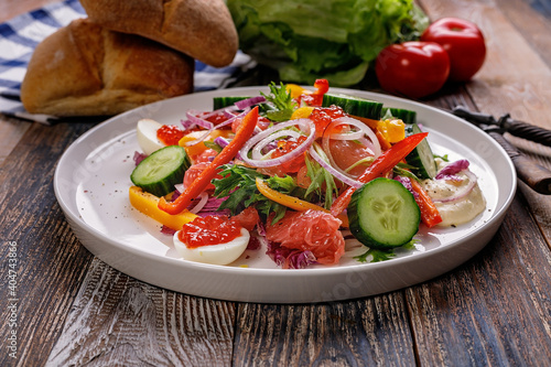 Delicious and healthy food. Salad with smoked trout, grapefruit, fresh cucumber, purple Chinese cabbage sweet peppers. Mediterranean diet recipes. Low calories meal.