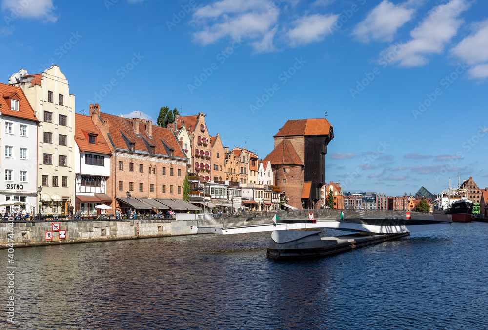 Fototapeta premium The largest medieval port Crane in Europe and historic buildings on the Dlugie Pobrzeze over the Motlawa River in Gdansk, Poland.