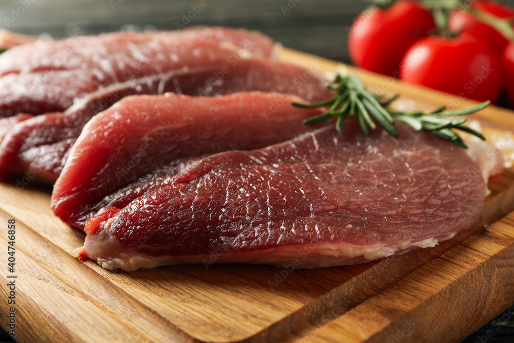 Board with fresh raw steak meat on wooden background Board with fresh raw steak meat on wooden background