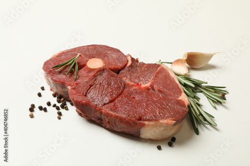 Fresh steak meat with herbs and spices on white background
