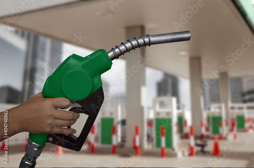Hand holds fuel nozzle on isolated background