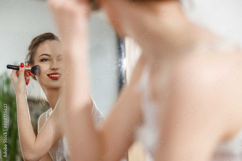 Beautiful young happy caucasian woman at cozy home with cosmetics at sunny morning Beautiful young happy caucasian woman at cozy home with cosmetics at sunny morning
