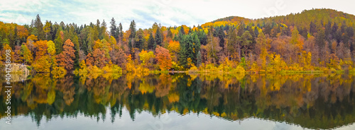 Monticolo lake in South Tyrol, Trentino Alto Adige, northern Italy. Panoramic view of the lake in autumn