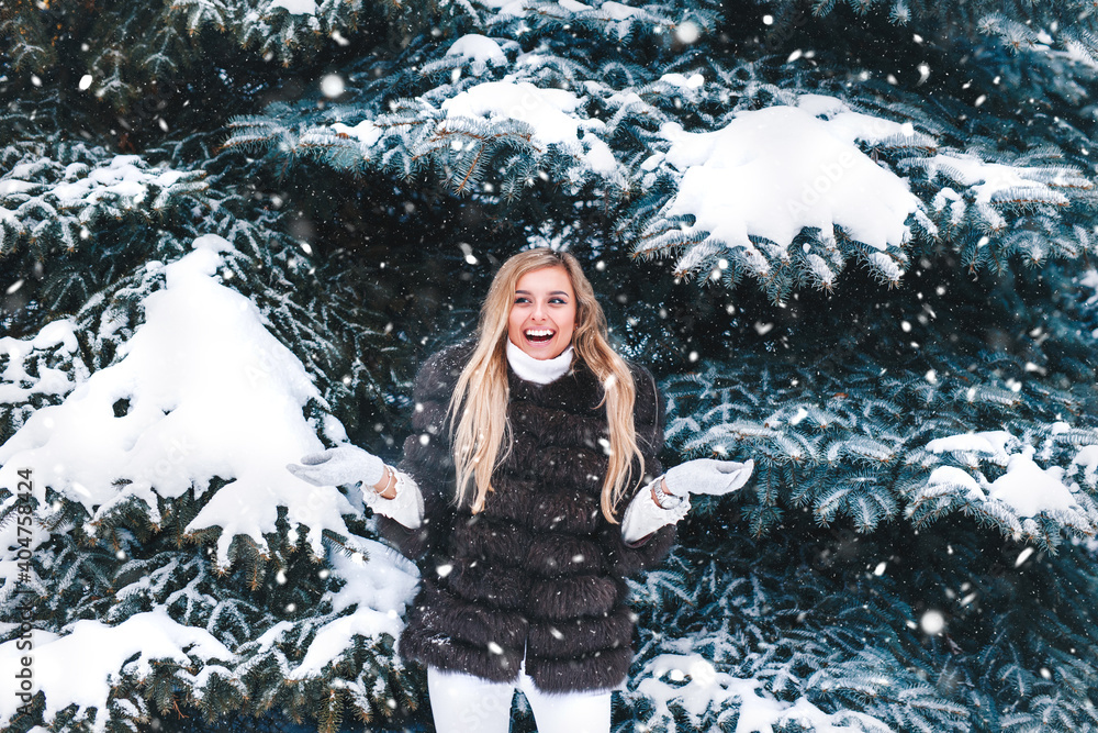 Happy woman throwing snow in the air at sunny winter day Happy woman throwing snow in the air at sunny winter day