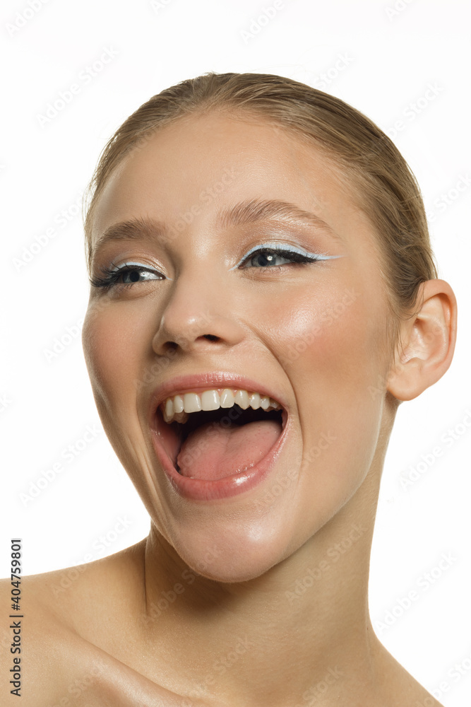 Vertical portrait of a happy smiling girl with perfect skin. Portrait on a white background Vertical portrait of a happy smiling girl with perfect skin. Portrait on a white background