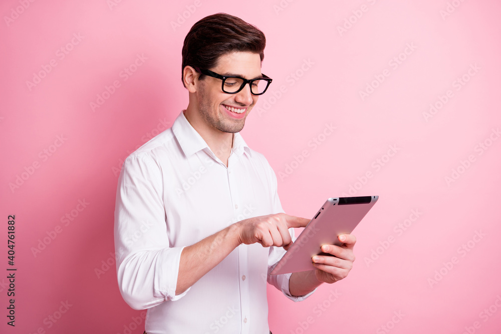 Profile portrait of optimistic guy write tablet wear spectacles white shirt isolated on pink color background Profile portrait of optimistic guy write tablet wear spectacles white shirt isolated on pink color background