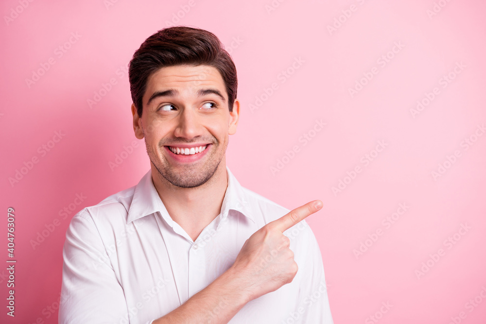 Portrait of glad person toothy smile look indicate finger empty space proposition isolated on pink color background Portrait of glad person toothy smile look indicate finger empty space proposition isolated on pink color background