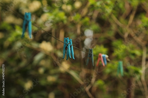 Blue clothespins hanging on a wire