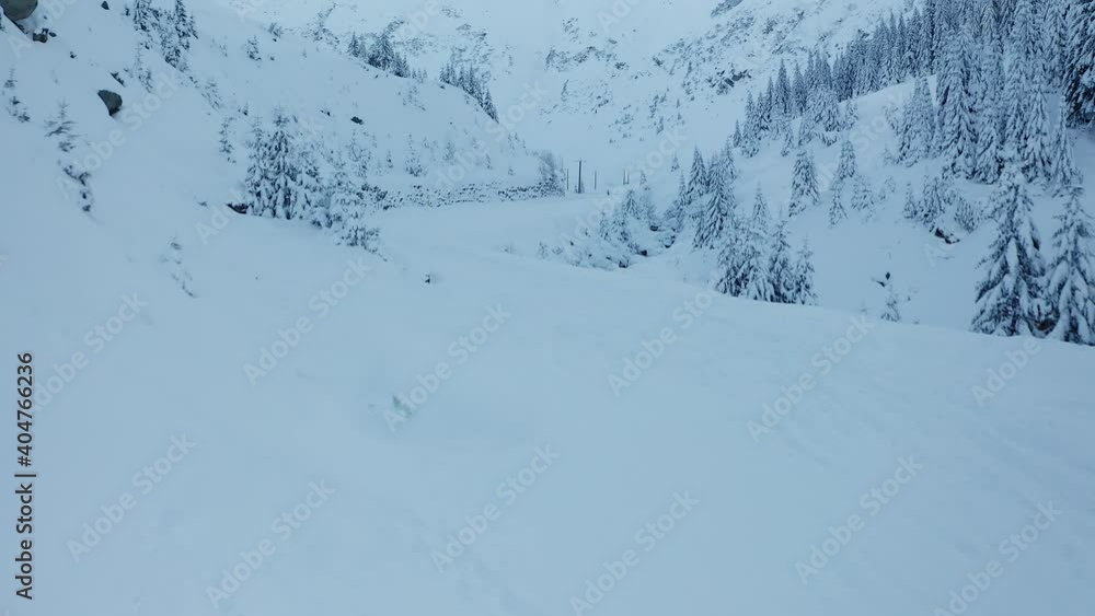 4K aerial drone view over Transfagarasan curved road trough the mountains in amazing winter landscape 4K aerial drone view over Transfagarasan curved road trough the mountains in amazing winter landscape