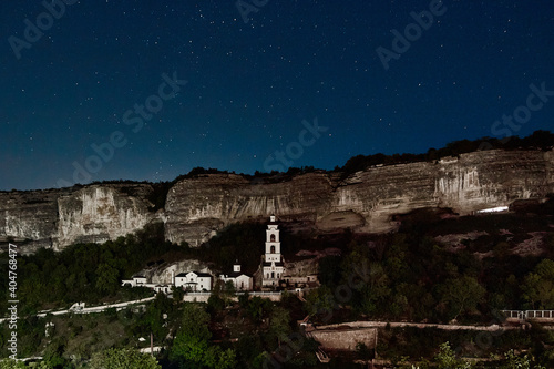 church on the background of mountains and starry sky (ID: 404768477)