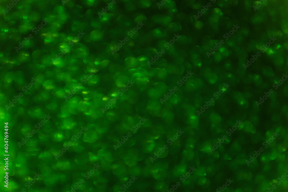 Blurred defocused background. Texture of green black bokeh. Template for St. Patrick's Christmas holiday greeting cards. Abstraction template. Copy space Layout for decoration Blurred defocused background. Texture of green black bokeh. Template for St. Patrick's Christmas holiday greeting cards. Abstraction template. Copy space Layout for decoration