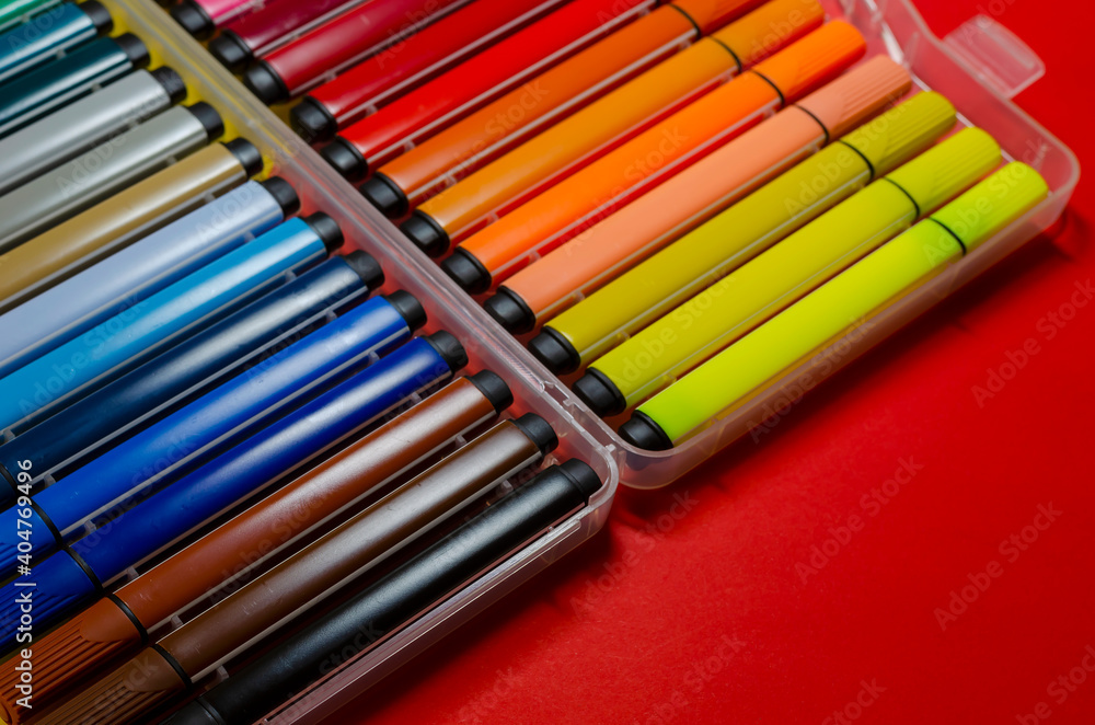 Fototapeta premium Large set of colorful felt-tip pens for drawing on a colored background.
