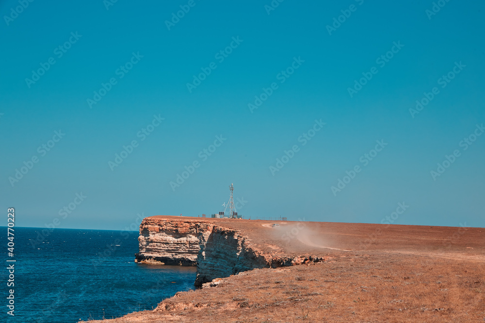 steep edge of a flat hill overlooking the sea steep edge of a flat hill overlooking the sea
