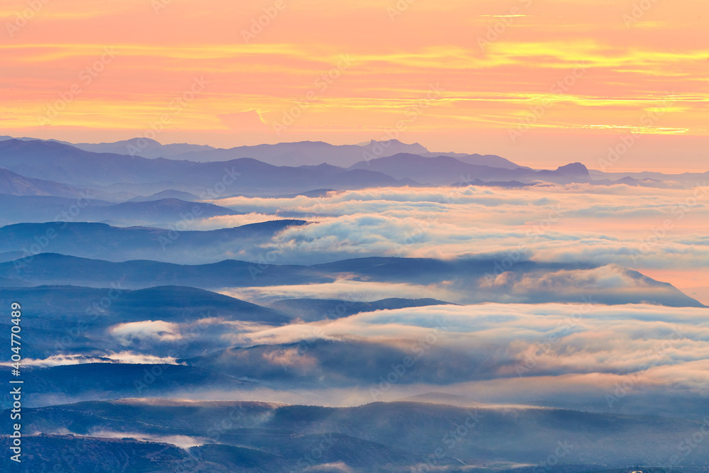 sunrise on the coast in clouds and mountains