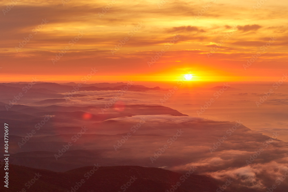 sunrise on the coast in clouds and mountains