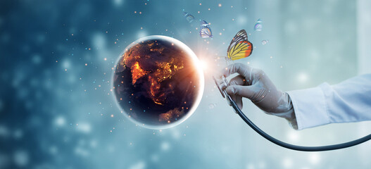 Earth at night being with butterfly checked by a doctor with a stethoscope. Environment and pollution. Save the world. Earth day. Energy saving concept.