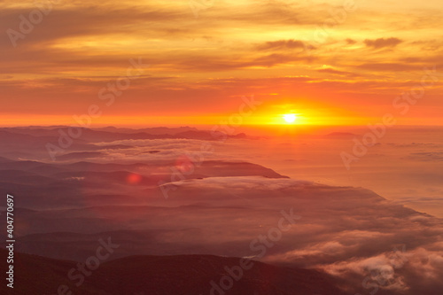 sunrise on the coast in clouds and mountains