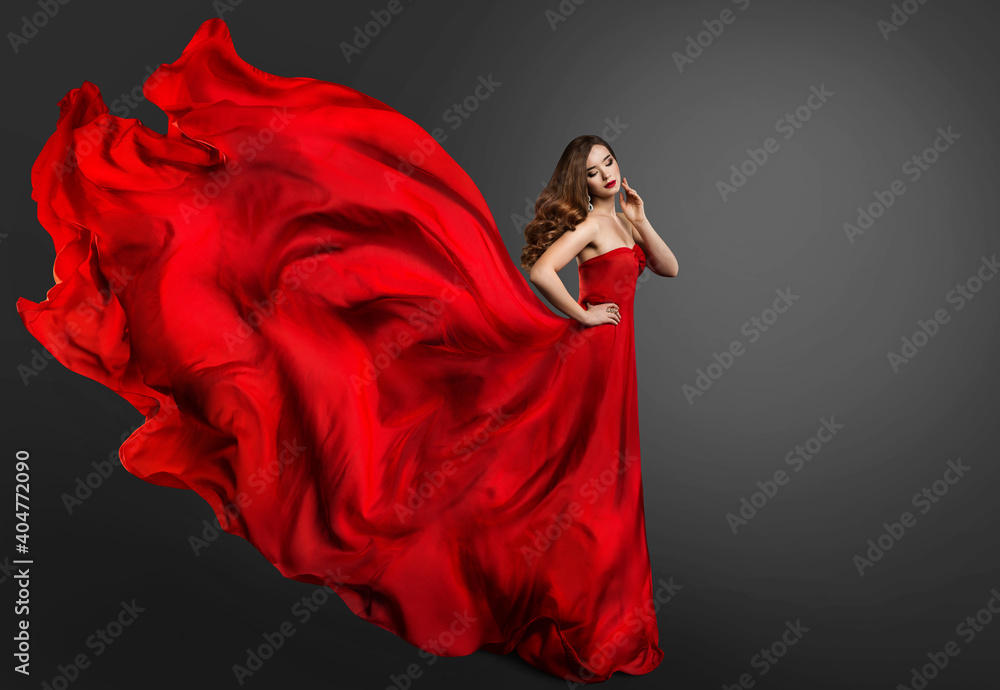 Fototapeta Woman Red Dress, Fashion Model in Long Silk Gown Waving on Wind, Fantasy Girl in Flying Fabric. Black Background