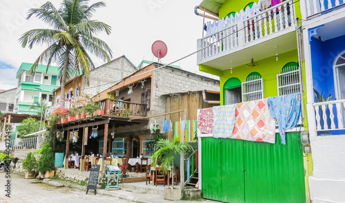 The old part of the city in colonial style with narrow cobblestone streets, red-roofed buildings and pastel houses. Guatemala. Flores, El Peten.