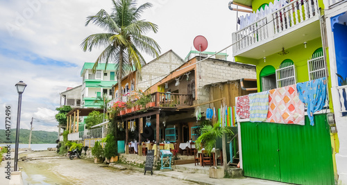 The old part of the city in colonial style with narrow cobblestone streets, red-roofed buildings and pastel houses. Guatemala. Flores, El Peten. photo