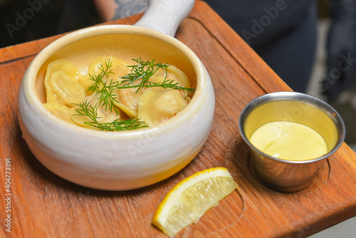 Close up fresh boiled dumplings. Served by waiter in restaurant or diner, still life, eating out concept.