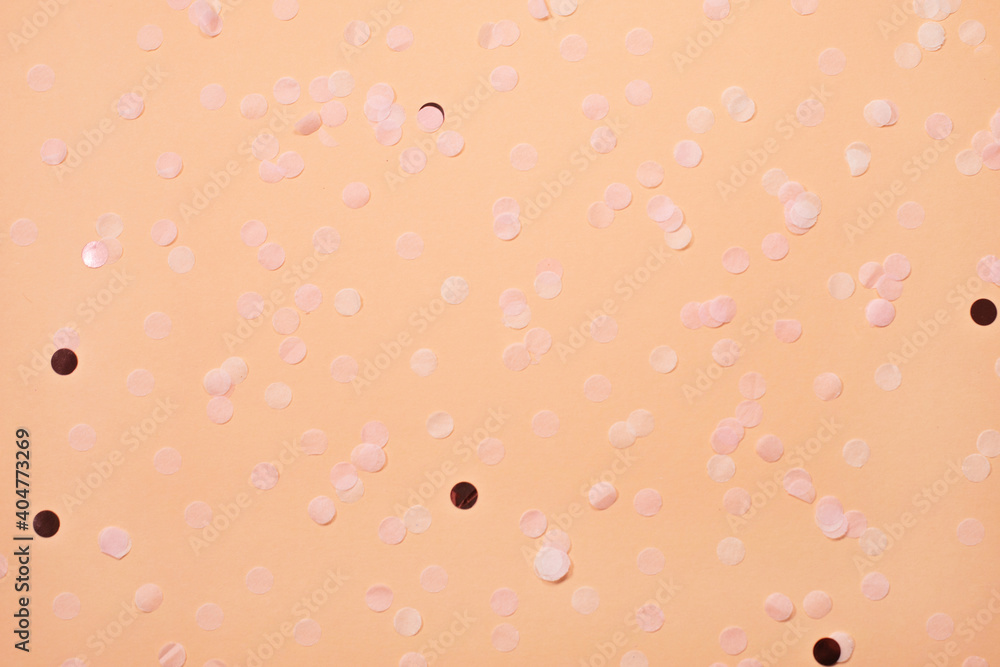 Pink confetti on Pastel beige background. Festive backdrop