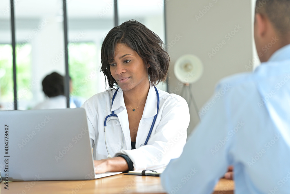 Portrait of young therapist meeting with patient in medical office Portrait of young therapist meeting with patient in medical office