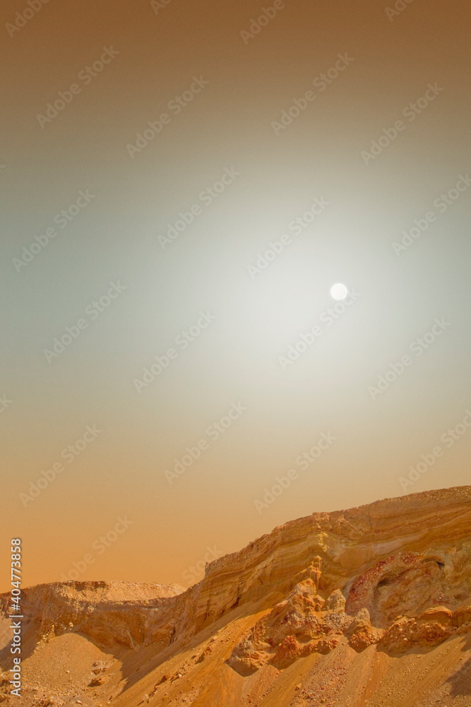 Red mars landscape with a hazy sky.